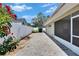 Paver patio features a fenced yard, side garden, and screened back porch at 2527 Wrencrest Cir, Valrico, FL 33594
