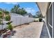 Paver patio with fenced yard, side garden, and access to the screened back porch at 2527 Wrencrest Cir, Valrico, FL 33594