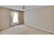 Neutral bedroom features a ceiling fan, a window with curtains and neutral carpeting at 2527 Wrencrest Cir, Valrico, FL 33594