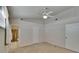Carpeted bedroom featuring a ceiling fan, bifold closet doors and an adjoining bathroom at 2527 Wrencrest Cir, Valrico, FL 33594