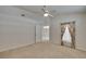 Bright bedroom with neutral carpet, ceiling fan, and a window draped with floral patterned curtains at 2527 Wrencrest Cir, Valrico, FL 33594