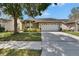 Well-manicured lawn and landscaping enhance the curb appeal of this lovely home at 2527 Wrencrest Cir, Valrico, FL 33594