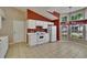 Eat-in kitchen featuring white cabinets, tiled floors, large windows, and modern appliances at 2527 Wrencrest Cir, Valrico, FL 33594