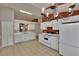 The eat-in kitchen showcases bright white cabinetry, matching appliances, and tile flooring at 2527 Wrencrest Cir, Valrico, FL 33594