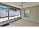 Enclosed lanai with tile floor and ceiling fan with view of the back yard at 2527 Wrencrest Cir, Valrico, FL 33594
