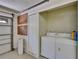 Bright laundry room with washer, dryer, and convenient storage in the garage at 2527 Wrencrest Cir, Valrico, FL 33594