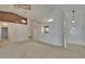 Open-concept living area with neutral carpet, high ceilings, and decorative lighting fixtures at 2527 Wrencrest Cir, Valrico, FL 33594