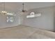 Spacious living room featuring neutral carpeting, ample natural light, and modern ceiling fan at 2527 Wrencrest Cir, Valrico, FL 33594