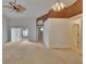 Bright living room with neutral carpet, fan, and sliding glass door leading to enclosed patio at 2527 Wrencrest Cir, Valrico, FL 33594