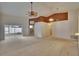 Bright living room with neutral carpet, fan, and sliding glass door leading to enclosed patio at 2527 Wrencrest Cir, Valrico, FL 33594