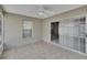 Tiled back porch features sliding glass doors, a window, and a ceiling fan at 2527 Wrencrest Cir, Valrico, FL 33594