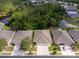 Aerial view showcasing the home's location with beautiful lake views, lush greenery, and neighborhood at 31201 Shaker Cir, Wesley Chapel, FL 33543