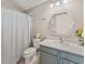 Bathroom with a shower, hexagon mirror, and updated fixtures at 31201 Shaker Cir, Wesley Chapel, FL 33543