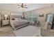 Bedroom with neutral walls, plush rug, tufted headboard and ceiling fan at 31201 Shaker Cir, Wesley Chapel, FL 33543