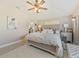 Bedroom featuring a soft, inviting bed, ceiling fan and access to the ensuite bathroom at 31201 Shaker Cir, Wesley Chapel, FL 33543