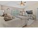 Bedroom boasting a plush bed, large TV, and a cozy ambiance at 31201 Shaker Cir, Wesley Chapel, FL 33543