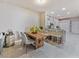 Dining area adjacent to the kitchen featuring a wooden table, upholstered chairs, and bar seating at 31201 Shaker Cir, Wesley Chapel, FL 33543