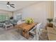 Open-concept dining area with natural wood table and modern chairs, seamlessly connecting to the living room at 31201 Shaker Cir, Wesley Chapel, FL 33543