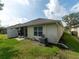 Exterior view of the home with a well-maintained lawn and easy access to a screened-in patio at 31201 Shaker Cir, Wesley Chapel, FL 33543