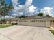 Charming home with a two-car garage, long driveway, and well-kept lawn and landscaping at 31201 Shaker Cir, Wesley Chapel, FL 33543
