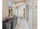 Bright hallway with high ceilings, modern floors, and decor with access to bathroom at 31201 Shaker Cir, Wesley Chapel, FL 33543