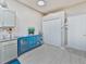 Hallway area features a blue accent cabinet, closet space, and access to other areas of the home at 31201 Shaker Cir, Wesley Chapel, FL 33543