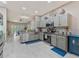 Modern kitchen features stainless steel appliances, gray cabinets, granite countertops, and seamless flow to the living area at 31201 Shaker Cir, Wesley Chapel, FL 33543