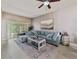 Cozy living room with a plush sectional sofa, stylish coffee table, and sliding glass doors at 31201 Shaker Cir, Wesley Chapel, FL 33543