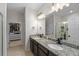 Bathroom boasts double sinks with granite countertops, with an adjacent shower and closet at 32718 Harmony Oaks Dr, Wesley Chapel, FL 33545
