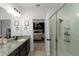 Bright bathroom featuring a vanity with a shower and view into the bedroom at 32718 Harmony Oaks Dr, Wesley Chapel, FL 33545