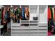 Organized walk-in closet with hanging rods, shelves, and drawers for ample storage at 32718 Harmony Oaks Dr, Wesley Chapel, FL 33545