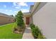 A welcoming front entrance with manicured landscaping and a pathway leading to the front door at 32718 Harmony Oaks Dr, Wesley Chapel, FL 33545