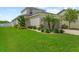 Beautifully landscaped front yard with lush green grass and well-maintained shrubs at 32718 Harmony Oaks Dr, Wesley Chapel, FL 33545