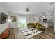 Comfortable living area featuring wood-look flooring, a sliding glass door with backyard view, and direct kitchen access at 32718 Harmony Oaks Dr, Wesley Chapel, FL 33545
