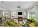 Bright living room with wood-look flooring, neutral walls, and seamless flow to dining area, creating an inviting space at 32718 Harmony Oaks Dr, Wesley Chapel, FL 33545