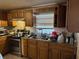 The kitchen area features wooden cabinets and dated appliances at 3311 W Saint Conrad St, Tampa, FL 33607