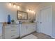 Elegant bathroom featuring a large vanity with ample storage and modern lighting fixtures at 3322 Cypress Landing Dr, Valrico, FL 33596