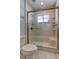 Shower with sliding glass door and shower head with seating and shelving at 3322 Cypress Landing Dr, Valrico, FL 33596