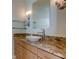 Bathroom vanity with granite countertop, white basin sink and modern faucet at 3322 Cypress Landing Dr, Valrico, FL 33596