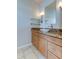 Bathroom vanity with granite countertop, white basin sink, and wood cabinets at 3322 Cypress Landing Dr, Valrico, FL 33596