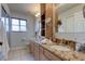 Bathroom with double vanity, granite countertops, sinks, and wood cabinets at 3322 Cypress Landing Dr, Valrico, FL 33596