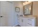 Bright bathroom features a decorative framed mirror, white vanity with drawers and cabinets and neutral paint at 3322 Cypress Landing Dr, Valrico, FL 33596