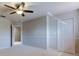 A bright, carpeted bedroom with a ceiling fan, white trim and baseboards, and a large closet at 3322 Cypress Landing Dr, Valrico, FL 33596