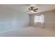 Airy bedroom featuring plush carpet, neutral walls, and a window with sheer curtains allowing natural light at 3322 Cypress Landing Dr, Valrico, FL 33596