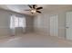 Well-lit bedroom boasts neutral colors, plush carpet, and ample natural light through a window with sheer curtains at 3322 Cypress Landing Dr, Valrico, FL 33596