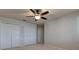 Spacious bedroom featuring a ceiling fan and double closets for ample storage at 3322 Cypress Landing Dr, Valrico, FL 33596