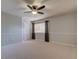 Bright bedroom with plush carpet, a ceiling fan, and a window flanked by dark brown curtains at 3322 Cypress Landing Dr, Valrico, FL 33596
