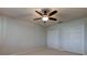 Neutral bedroom features two white closets and a ceiling fan with light at 3322 Cypress Landing Dr, Valrico, FL 33596