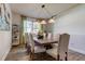 Inviting dining room featuring stylish chairs, rustic table, and elegant light fixture at 3322 Cypress Landing Dr, Valrico, FL 33596