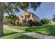 Stunning two-story home featuring a well-manicured lawn and professional tropical landscaping at 3322 Cypress Landing Dr, Valrico, FL 33596